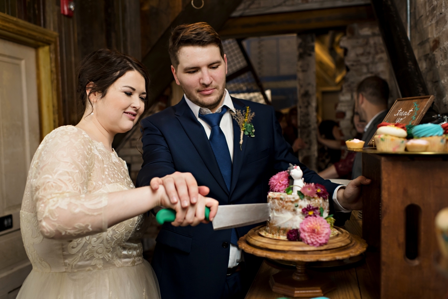 A wedding couple cut the wedding cake.